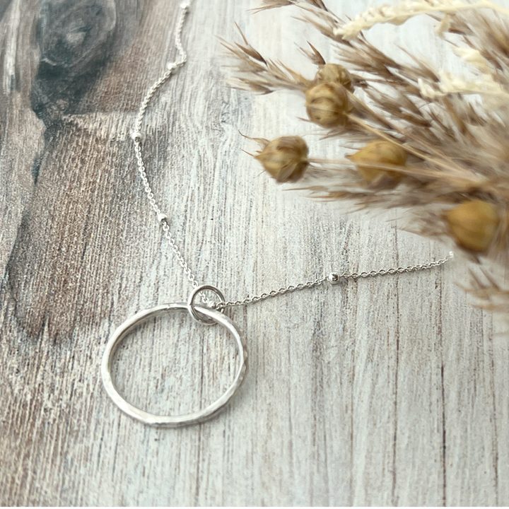 Aurora Unity Sterling Silver open circle pendant necklace - showing a close-up of the hand-hammered texture on the circle pendant.