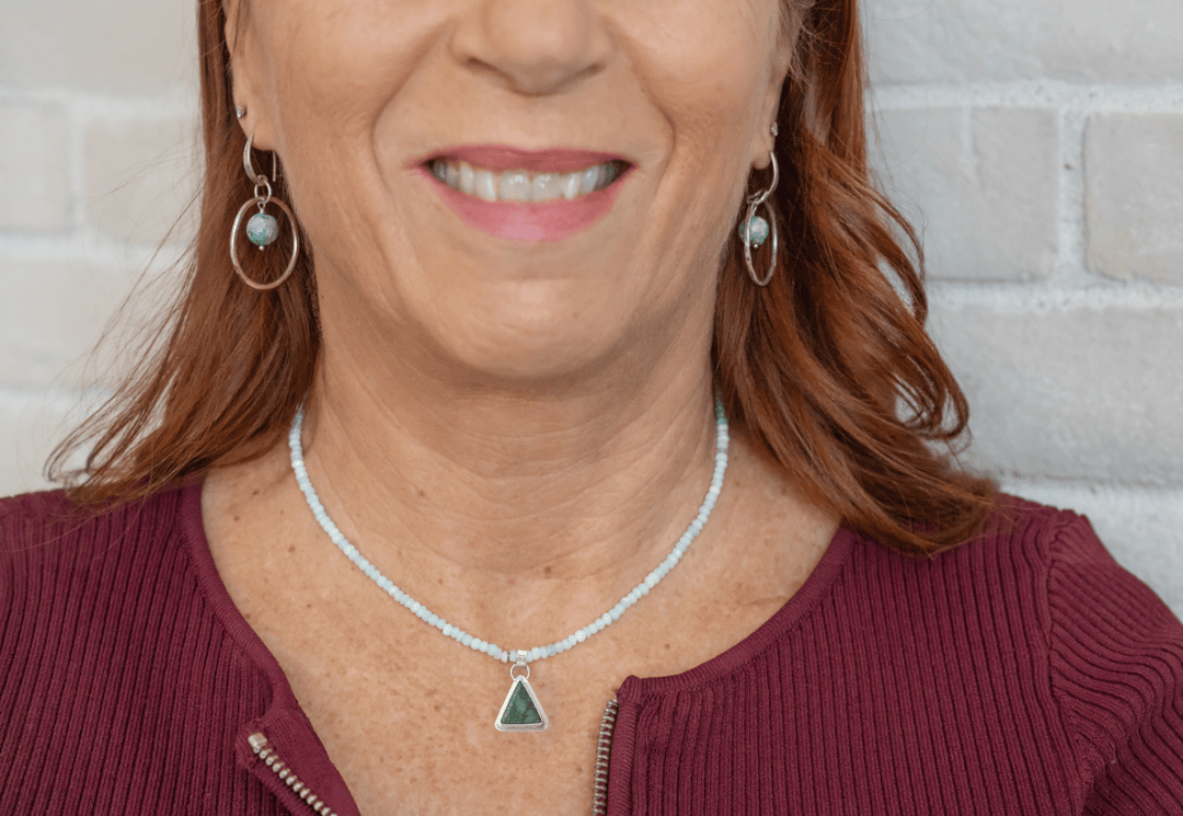 Woman wearing the Peruvian Blue Opal & Crescent Lake Variscite Necklace and Turquoise Beaded Hoop earrings.