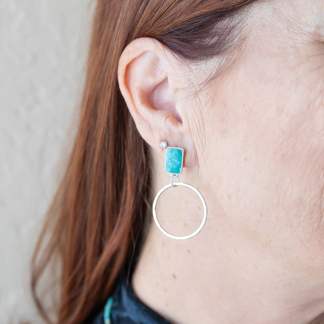 Turn heads with these one-of-a-kind Turquoise stud hoops, crafted with sterling silver and adorned with natural Turquoise. 