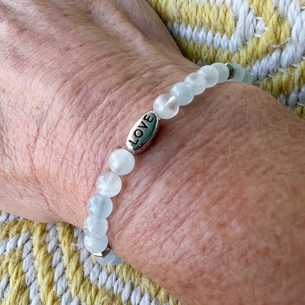 LOVE in the Waves bracelet worn on wrist.